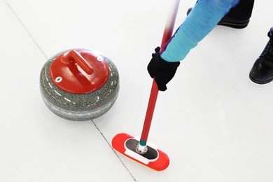 curling game. the player plays curling on the ice rink