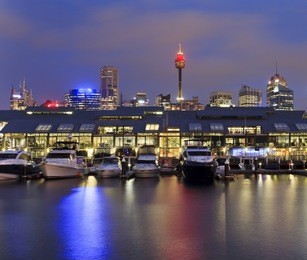 sydney pyrmont bay view on docks with marina boats at sunrise sydney tower above roofs of apartments