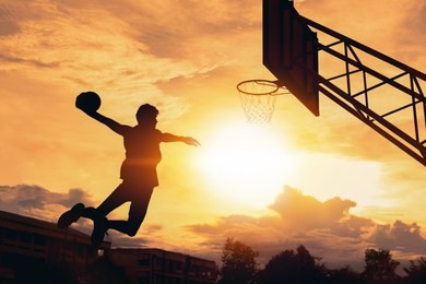 basketball player performs a slam dunk