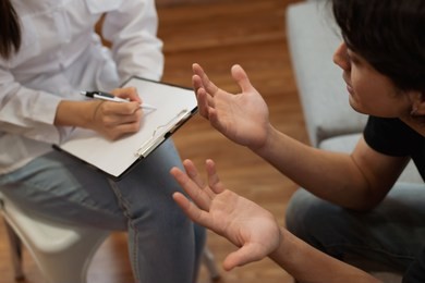 young asian man received a treatment from psychologist at clinic.