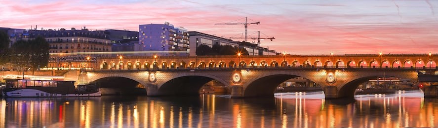 the panoramic view of bridge bercy at sunset, paris, france. it is a vital artery between the two banks, and although the bridge has been enlarged, the original was constructed back in the 1800s.
