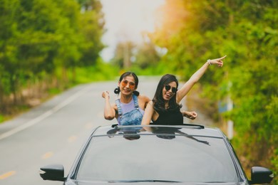 asian traveler woman stand at car sunroof enjoy roadtrip