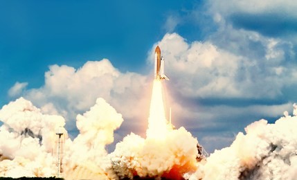 launch of the spaceship from the spaceport by day. space shuttle in clouds of smoke on the background of dramatic sky. some elements of this image are furnished by nasa