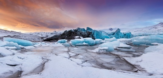 famous fjallsarlon glacier and lagoon with icebergs swimming on frozen water, southern iceland, europe.