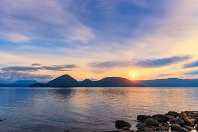 sunset at toya lake and island in the middle 
