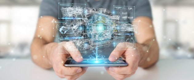 businessman using wireframe holographic 3d digital projection of an engine with mobile phone