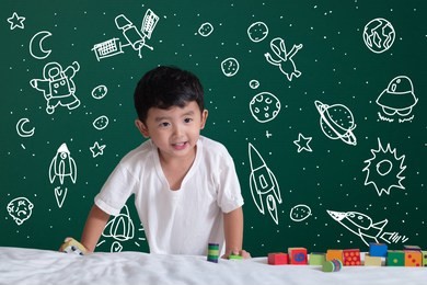 asian kid learning by playing with his imagination about science and space adventure, hand drawn on the green chalkboard, education back to school and discovery concept idea.