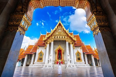 women tourists at wat benchamabophit or the marble temple in bangkok, thailand.