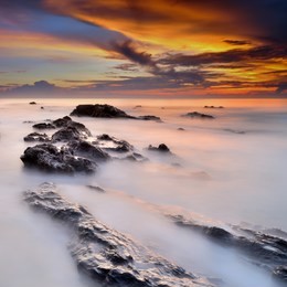 tropical rocky beach at sunrise ( long exposure photography), soft effect due to long exposure shot.
