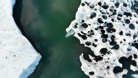aerial drone view of icebergs and glaciers in iceland