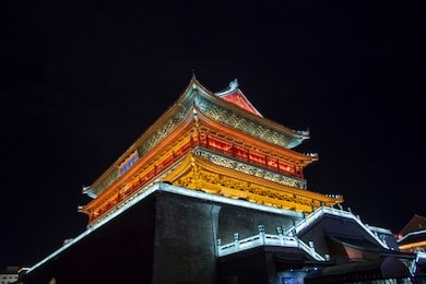 front of colorful drum tower illuminated at night in xi'an, china.