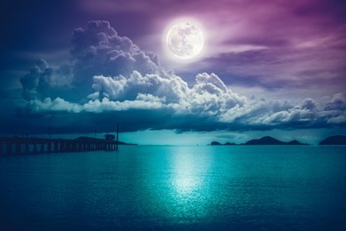 beautiful landscape view of the sea. colorful sky with clouds and bright full moon on seascape to night. serenity nature background, outdoor at nighttime. the moon taken with my own camera.