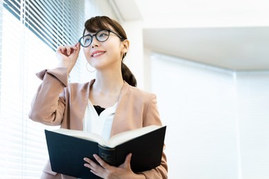 portrait of asian woman holding a book.