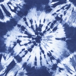abstract tie dyed fabric of indigo color on white cotton. hand painted fabrics. shibori dyeing
