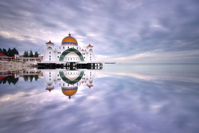 beautiful reflections of malacca straits mosque (masjid selat melaka), a mosque located on malacca island near malacca town in malacca state, malaysia.

