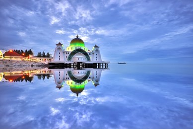 beautiful reflections of malacca straits mosque (masjid selat melaka), a mosque located on malacca island near malacca town in malacca state, malaysia.
