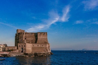 view of the ovo castle in naples, italy at dusk
