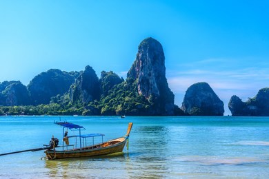 long tail boat on tropical beach, tonsai bay, railay beach, ao nang, krabi, thailand