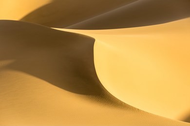 desert sand dunes closeup,sunset light with beautiful lines and dramatic shadows