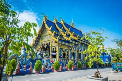wat rong sua ten temple with blue sky background, chiang rai province, thailand, it's a popular destination and landmark of chiang rai