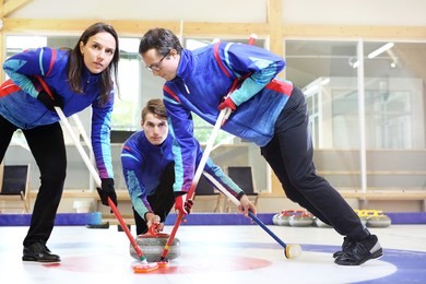 curling, team playing on the ice.