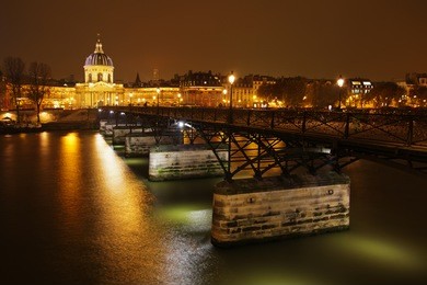 view of the famous bridge pont des arts in paris by night