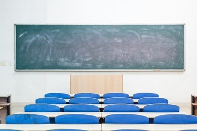 empty classroom with tables and chairs