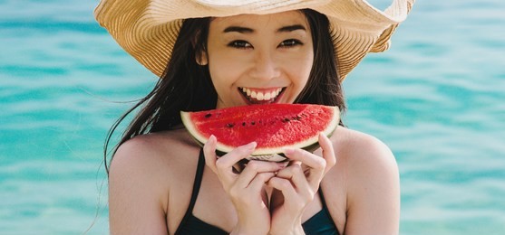 young asian happy healthy summer, vitality, care,  freedom, concept. woman with watermelon on the beach.