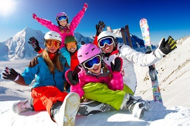 skiing, winter, snow, sun and fun - family enjoying winter vacations