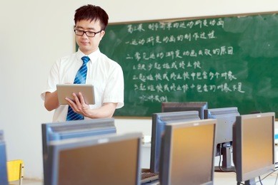 asian male teachers are using a tablet pc