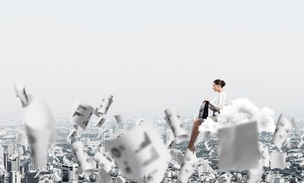 young elegant woman with suitcase in hands siting on cloud