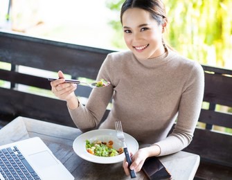 asian woman are working and eating salads.