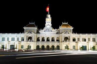the city hall of ho chi minh, capital of vietnam with streak of traffic lights