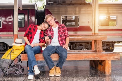 young traveling backpacker on vacation at the train station, travel concept