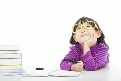 little girl  thinking or dreaming during preparing homework