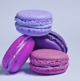 many macaroons on violet neon background. minimalism
