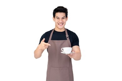 service minded handsome smiling asian barista serving coffee studio shot isolated on white background