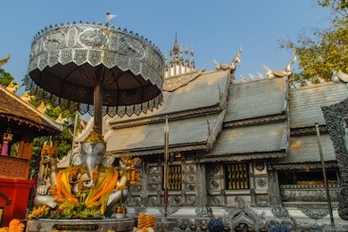 silver ganesha statue under umbrella at wat sri suphan, chiang mai, thailand. wat srisuphan also known as the silver temple because of its impressive hand crafted silver ordination hall decoration.