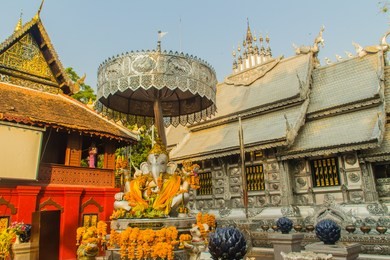 silver ganesha statue under umbrella at wat sri suphan, chiang mai, thailand. wat srisuphan also known as the silver temple because of its impressive hand crafted silver ordination hall decoration.