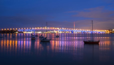 night view to the iconic harbour bridge auckland new zeland; light performance seeing from birkenhead wharf