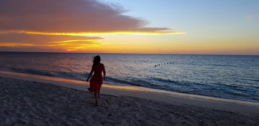 young lady enjoys sunset on the beach. varadero, cuba