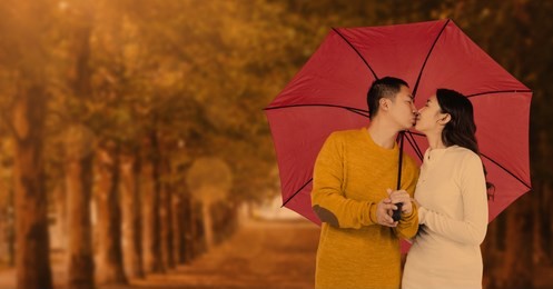 digital composite of autumn couple under umbrella in front of trees