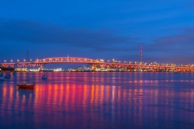 night view to the iconic harbour bridge auckland new zeland; light performance seeing from birkenhead wharf