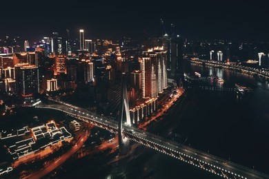 aerial view of bridge and city urban architecture at night in chongqing, china.