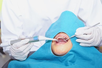 dentist examining a patient's teeth in the dentist. the concept of dental treatment in a dental clinic.