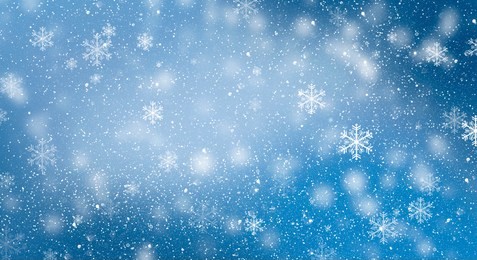 blue bokeh background with snowflakes. empty winter background, snowy, celebratory.