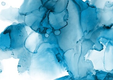 blue alcohol ink wash texture on white paper background. liquid paint flow. transparent ethereal effect.