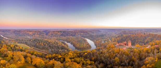 amazing aerial panoramic view over the turaida castle and autumn forest during sunset, sigulda, latvia, touristic place, beautiful wallpaper