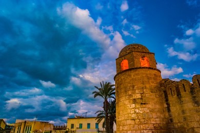 night photo of mosque in sousse. medieval architecture in night lights. vivid picture of ancient religious building - one of the main attractions in sousse, tunisia.