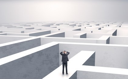 small businessman in a middle of a huge maze